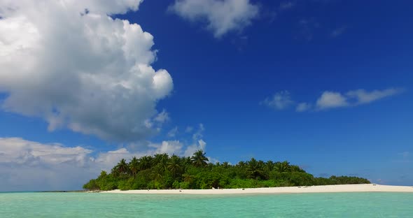 Daytime above island view of a paradise sunny white sand beach and turquoise sea background in colou