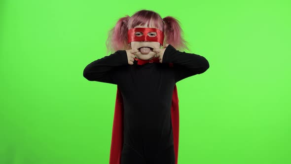 Funny Child Girl in Costume and Mask Plays Super Hero. National Superhero Day