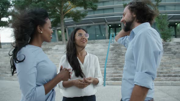 Three People Standing Outside Office Building and Communicating