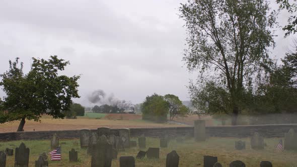 Antique Steam Train Traveling Thru Countryside Blowing Smoke and Steam on a Rainy Foggy Day