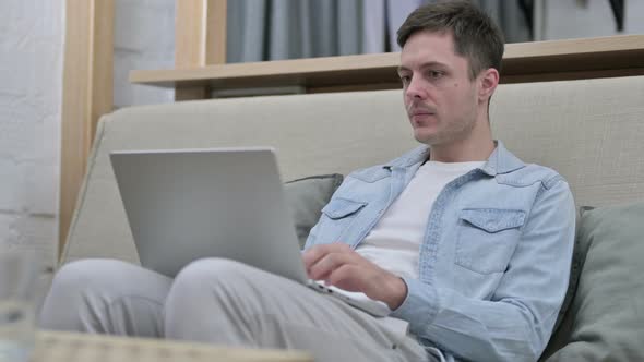 Young Man Closing Laptop and Leaving Room 