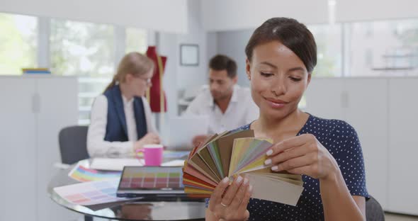 Portrait of Fashion Designer Holding Color Palette in Workshop