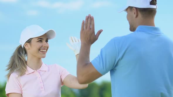 Attractive Male and Female Golf Competitors Thanking Each Other for Good Game