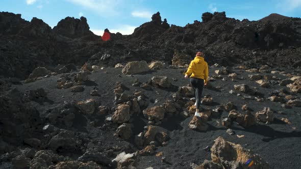 Woman Traveler Walks Through the Lava Field Around Chinyero Volcano in the Teide National Park on