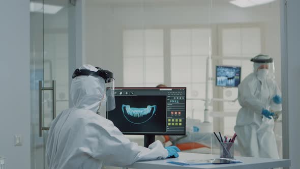 Orthodontists Analyzing Virtual Teeth Animation at Oral Clinic