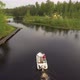 Camera Follows the Boat Sailing on the River Aerial Image - VideoHive Item for Sale