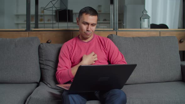 Hearing Impaired Man Video Conferencing on Laptop