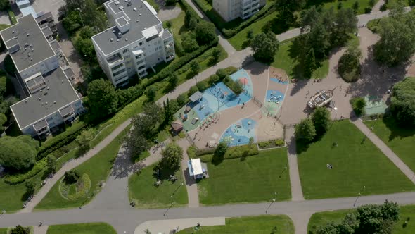 Top down aerial view of a colorful playground in a park, Finland.