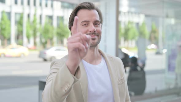 Young Man Pointing at the Camera Outdoor