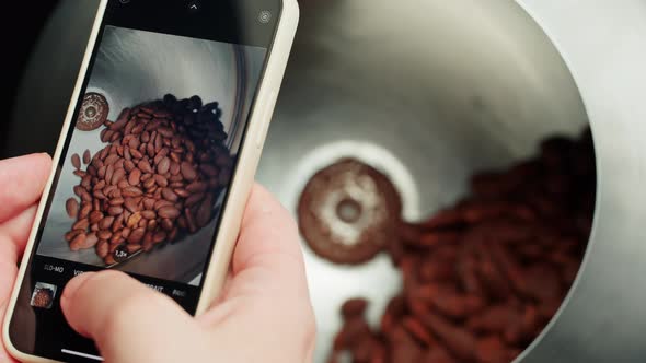 Taking Photo of Almond in Chocolate on Smartphone Camera Production of Nuts in Dark or Milk