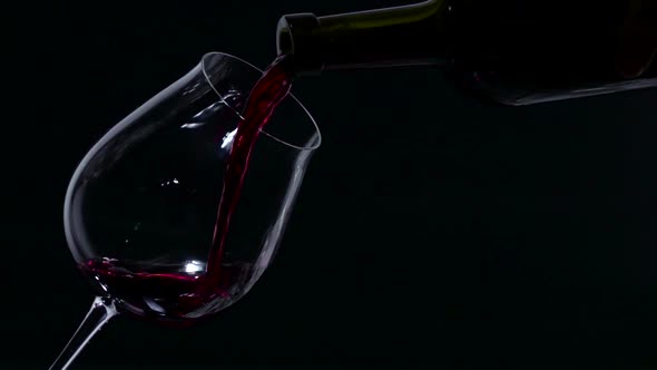 Red Wine Splash on a Glass, Black, Slowmotion, Closeup