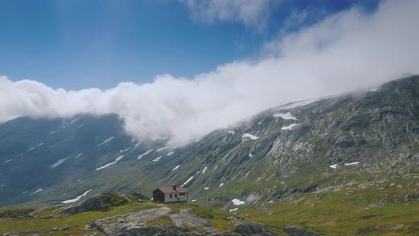 Ride Near the Picturesque Mountain Landscape of Norway, Drive Past a Lone Wooden House