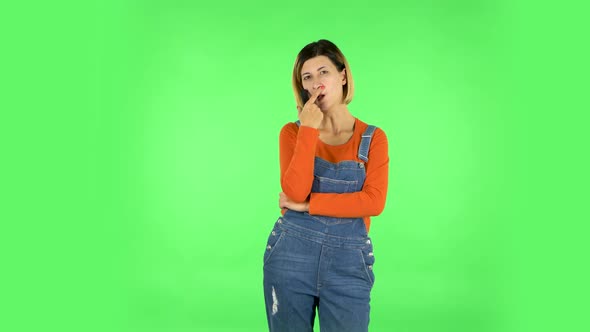 Woman with TV Remote in Her Hand, Switching on TV. Green Screen