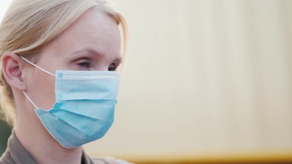 Portrait of a Woman in a Mask Near the Dusty Road