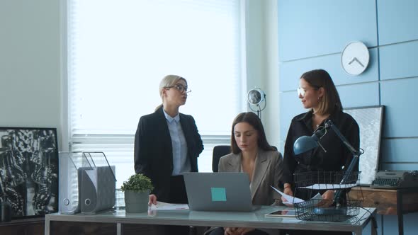  Women at a business meeting talking to colleagues about a new project