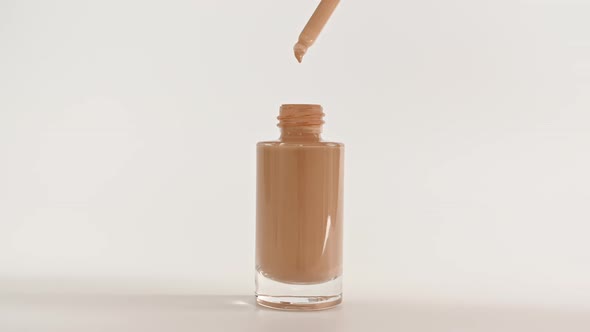 Foundation for Face Concealer Cosmetic Liquid Foundation Drips From a Pipette Into a Bottle