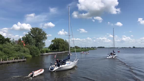 Frisian lake with boats passing by in Friesland, The Netherlands