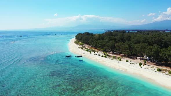 Wide angle overhead copy space shot of a summer white paradise sand beach and blue ocean background 