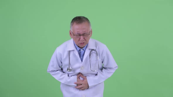 Stressed Mature Japanese Man Doctor Having Stomachache