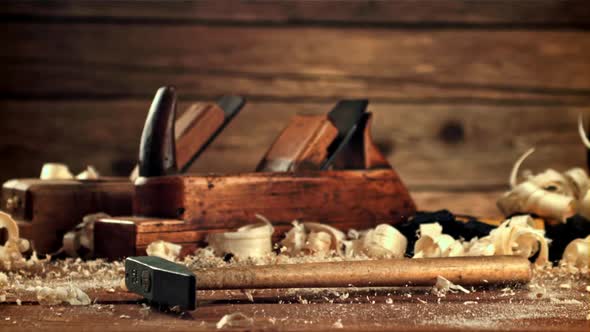 A Hammer Falls on the Table with Sawdust