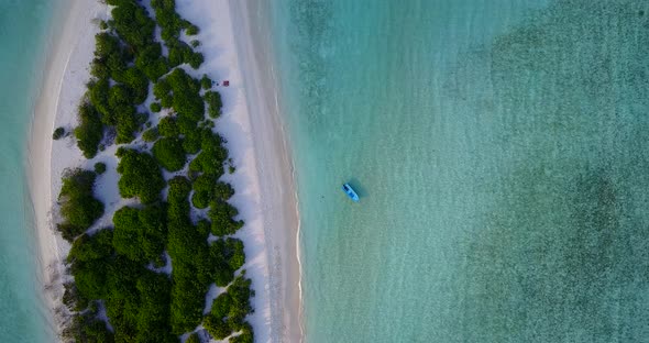Wide angle flying copy space shot of a white paradise beach and blue sea background in hi res 