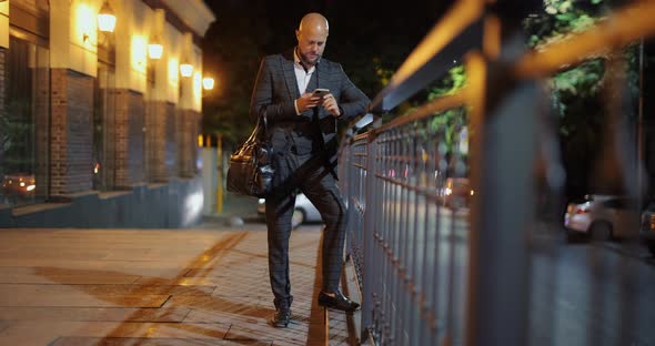 Businessman Using Smartphone at the Night City