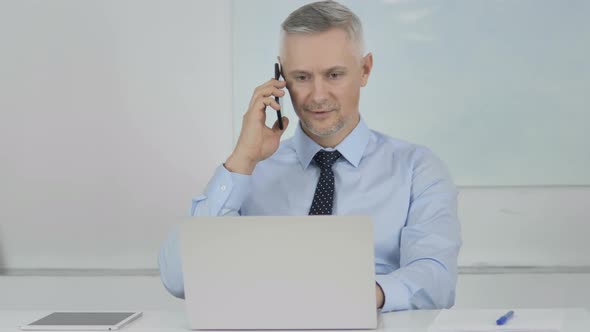 Senior Businesswoman Talking on Phone, Discussing with Customer