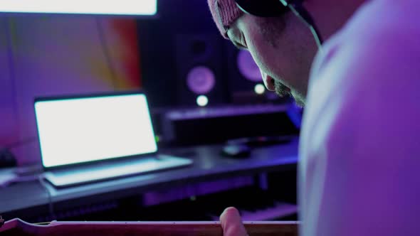 Musician playing the guitar in his studio