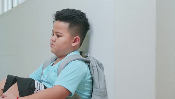 Asian Little Boy Sitting Alone With Sad Feeling At School. Bullying, Discrimination And Racism