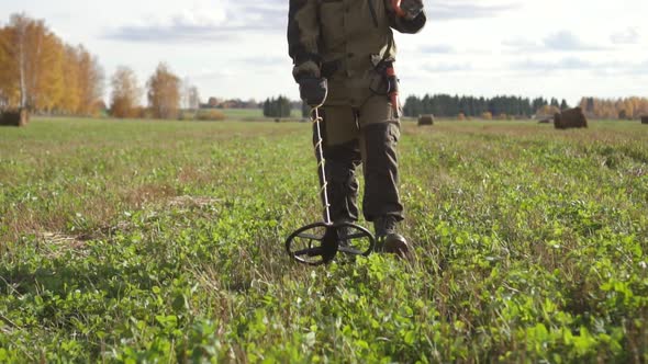 Male Treasure Hunter Uses Metal Detector