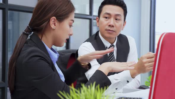 Asian young business man and woman people group having a discussion brainstorming meeting in office