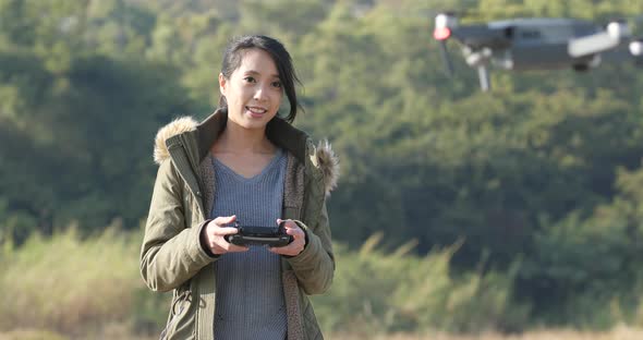 Woman wearing winter jacket and use of mobile phone at outdoor