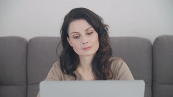 Freelancer woman doing distant work from home with laptop computer