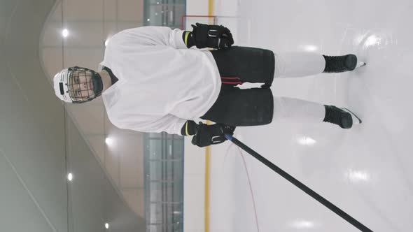 Male Hockey Player Standing On Empty Rink