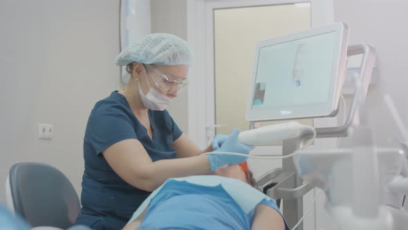 Doctor Woman Makes a 3d Scan of the Teeth of a Female Patient