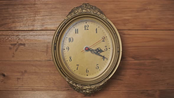 Old Retro Wall Clock with Moving Second Hand on Wooden Background