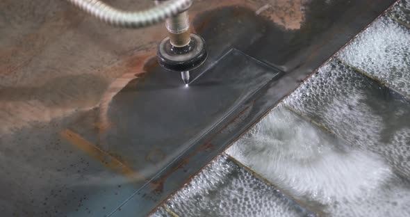 Waterjet CNC Machine Under Pressure Cutting Elements Out of Metal Sheet