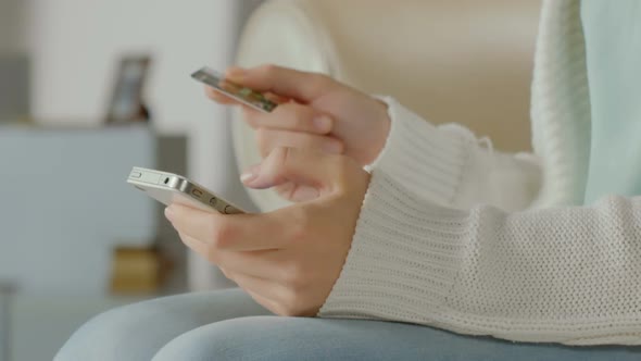 Close-Up of Woman's Hand Inserting Card Number on Smartphone, Paying Bills