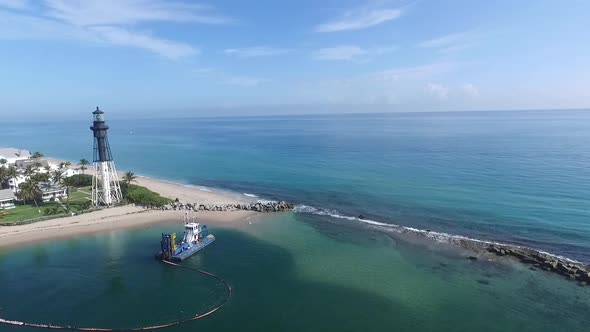 Peaceful coastline panorama with lighthouse and yacht