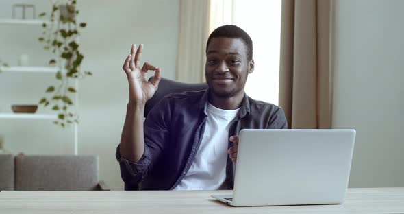 Portrait of Smiling African American Business Man Sitting with Laptop at Desk, Working on Internet