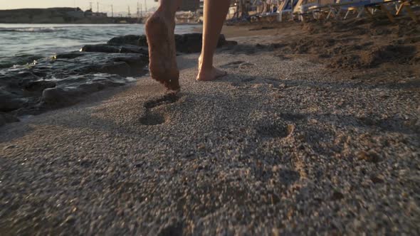 Beautiful Scene of a Woman Walking on Ocean Beach at Sunset