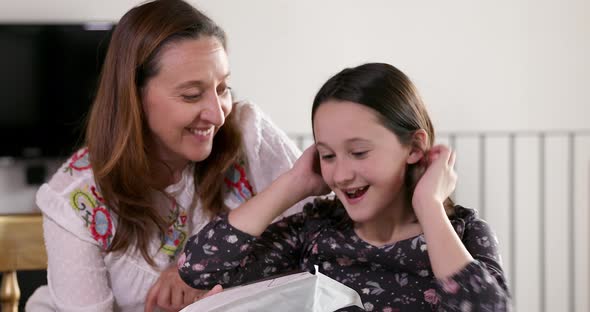 Mother giving gift to daughter