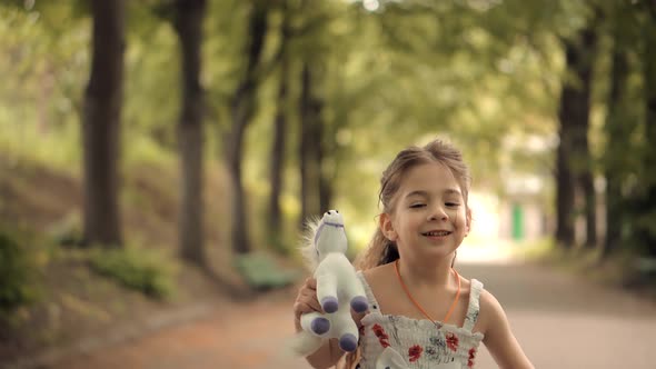 Little Girl Running Away Parents. Happy Cheerful Family Having Fun In Park. Cute Preschool Kid.