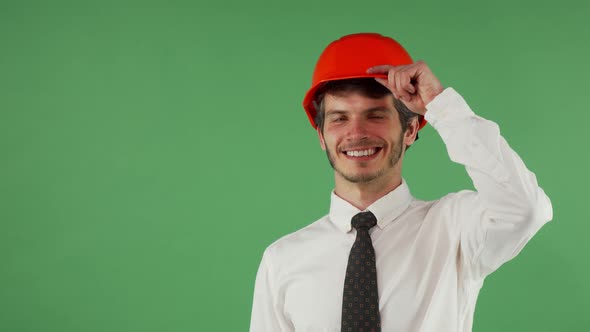 Cheerful Handsome Male Engineer Wearing Hardhat Winking To the Camera