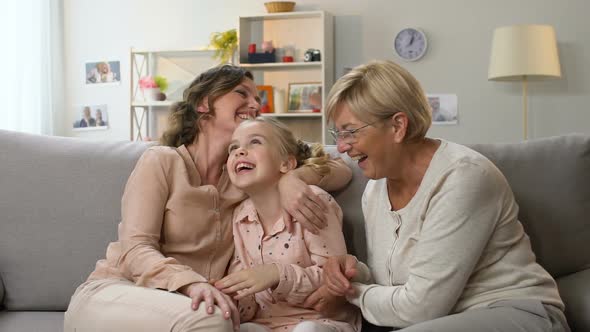 Little School Girl Laughing With Mother and Granny, Family Having Fun Together