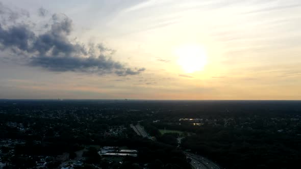 a high angle aerial view over a parkway in the morning at sunrise. It is a time lapse shot taken wit