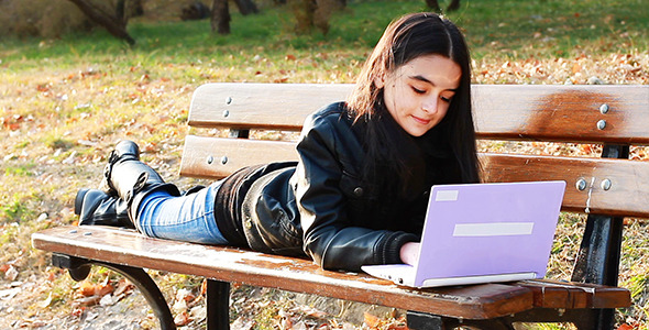 Teenager Sitting On Bench With Laptop 2
