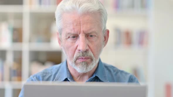 Close Up of Old Businessman Working on Laptop