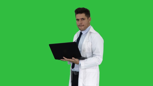 Cheerfull doctor with laptop laughing after giving a serious