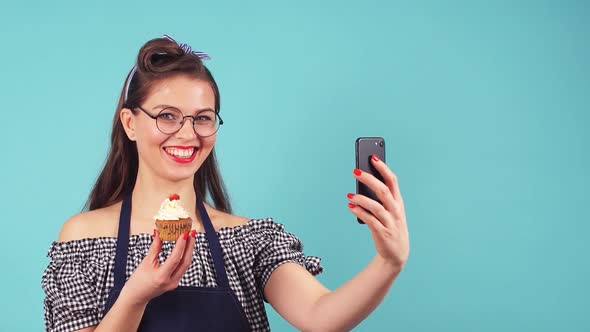 Cute Pastry Girl Doing Selfie with Cupcake in Hand